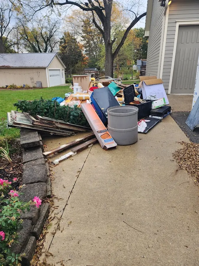 Dumpster being loaded with debris for Roofing Dumpster Rental in Cherry Valley